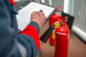 Checking A Fire Extinguisher Using Clipboard or checking Industrial fire control system