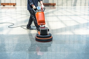 man cleaning floor with machine | commercial property floor cleaning service
