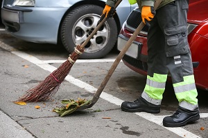 man sweeping in the parking lot | commercial facility cleanup
