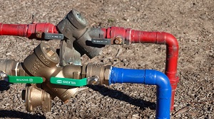 red and blue water lines with backflow preventer | commercial plumbing services